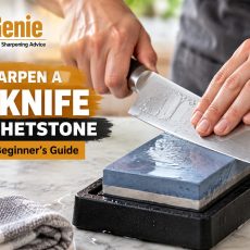 Hands sharpening a chef knife with a whetstone on a secure non-slip base.